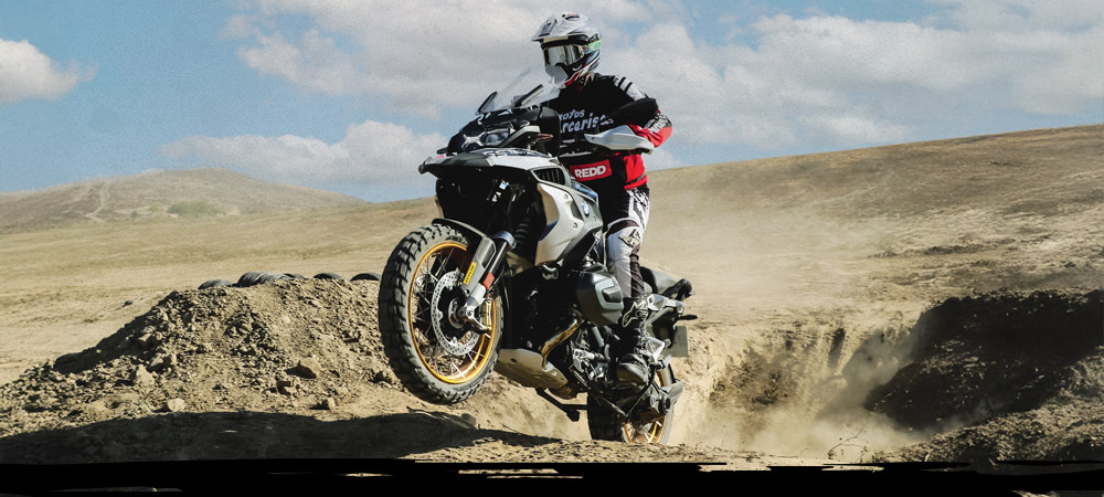 BMW 1200 GS riders on a dusty track on Dunlop Trailmax Mission tyres