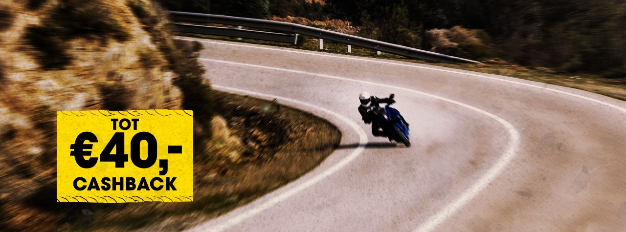 BMW S 1000 XR riding on Dunlop Mutant tyres with mountains in the background